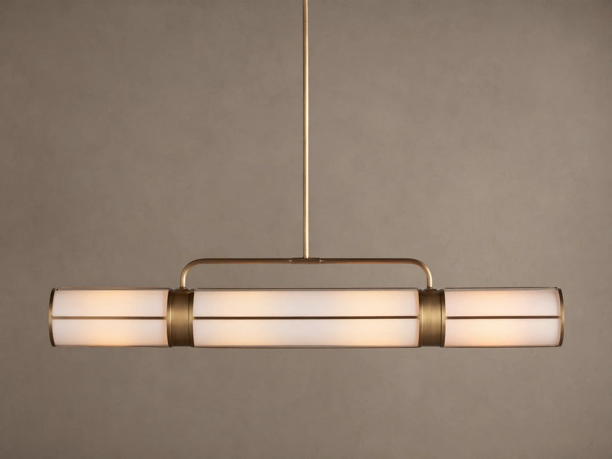 Remming Linear Chandelier: horizontal fixture with three glowing milk glass shades and burnished brass framework.