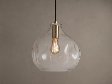 Organic 12" Pendant: Clear, mouth-blown seeded glass, organic-shaped shade with brass fitting, black cord, and warm vintage bulb.
