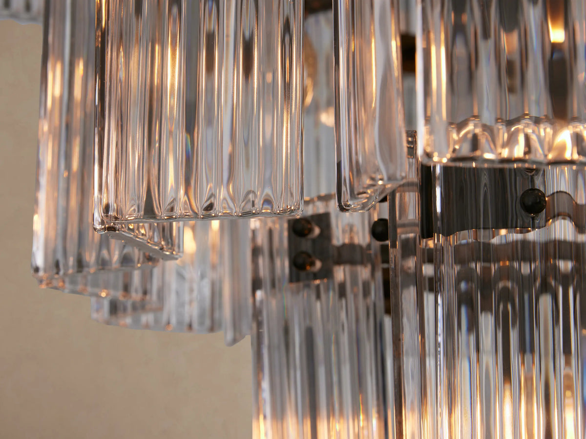 Delsie Round Chandelier, a large tiered fixture composed of many vertical clear glass rods, creating a cascading conical shape.