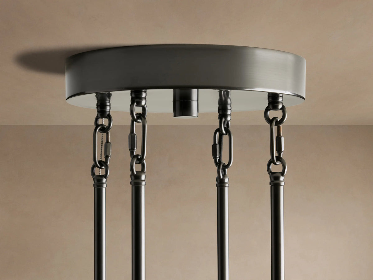 Detail of Delsie Round Chandelier. Vertical, fluted amber-tinted glass rods glow with warm light from within.
