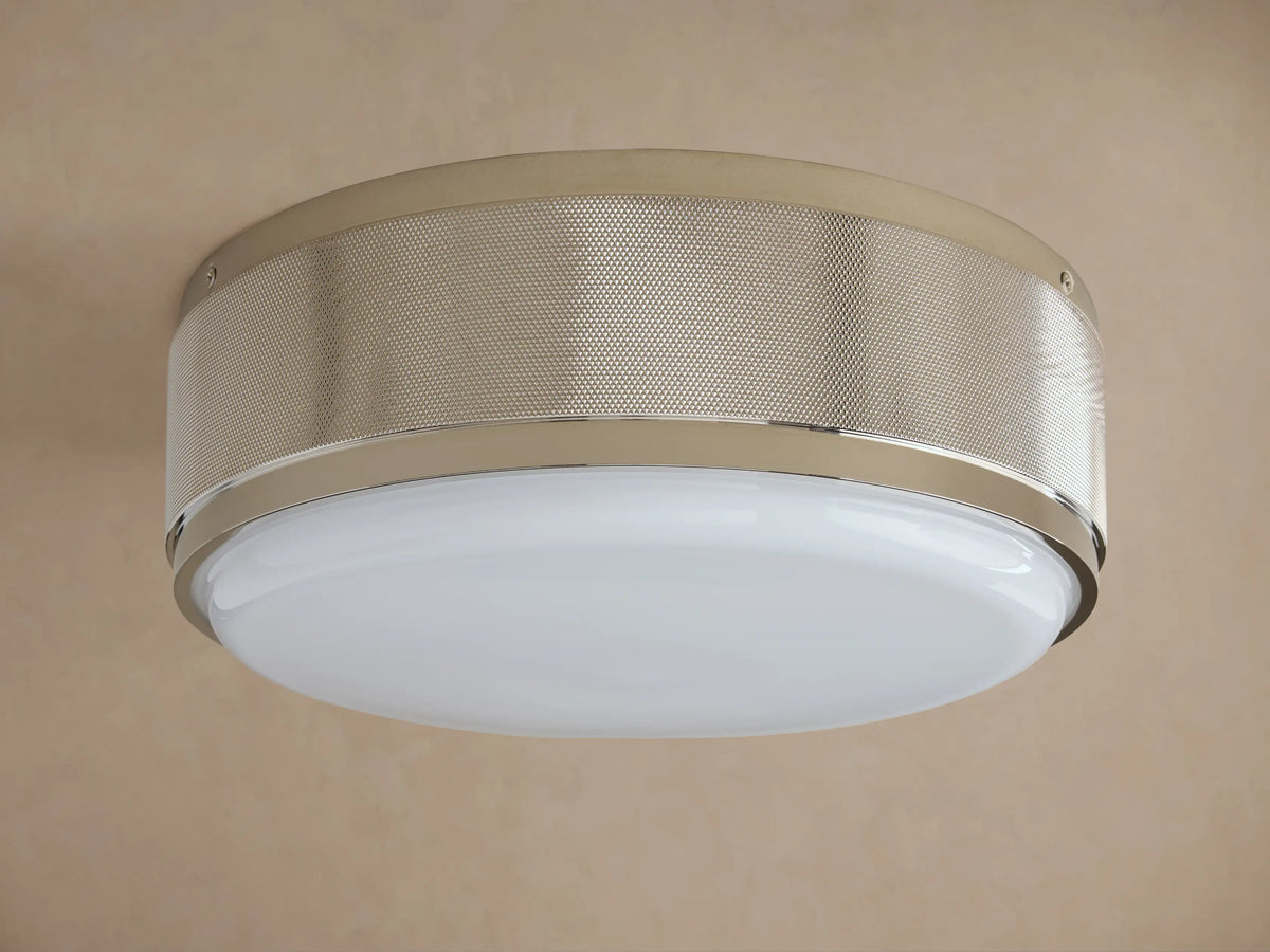 Round ceiling light with a brushed metal frame and frosted glass diffuser. Soft warm glow, mounted on a neutral-colored ceiling.