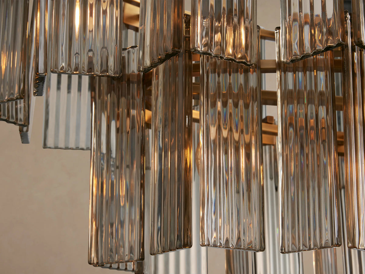 Delsie Oval Tiered Chandelier with two tiers of clear fluted glass panels and a burnished brass frame.