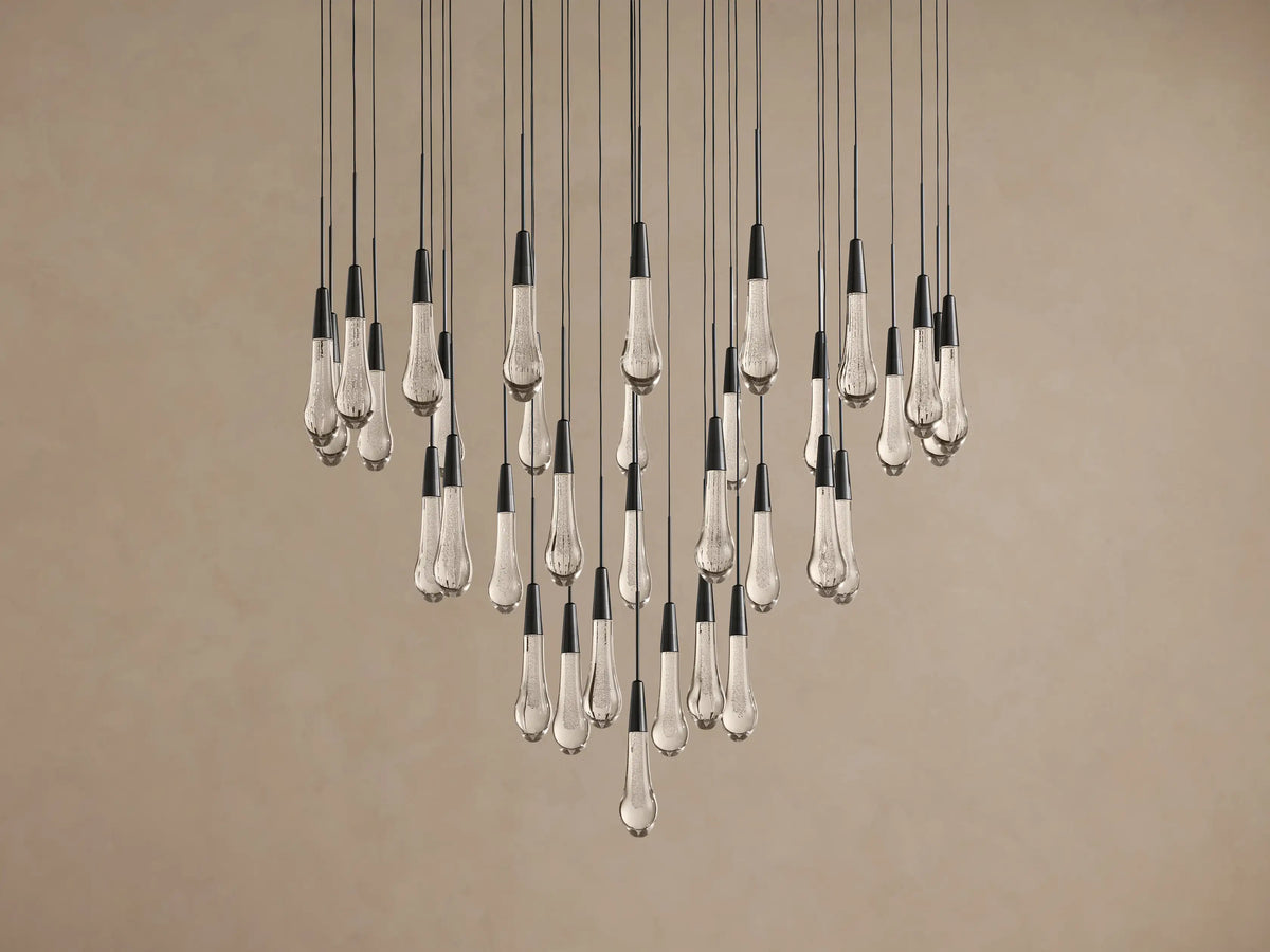 Soltaire Round Chandelier: many clear, bubble-filled teardrop glass lights with black caps, hanging at varying lengths.