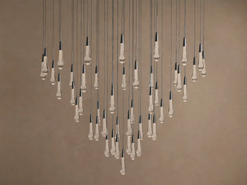 Soltaire Round Chandelier with multiple clear, textured, teardrop glass bulbs, dark metallic caps, suspended at varying lengths.