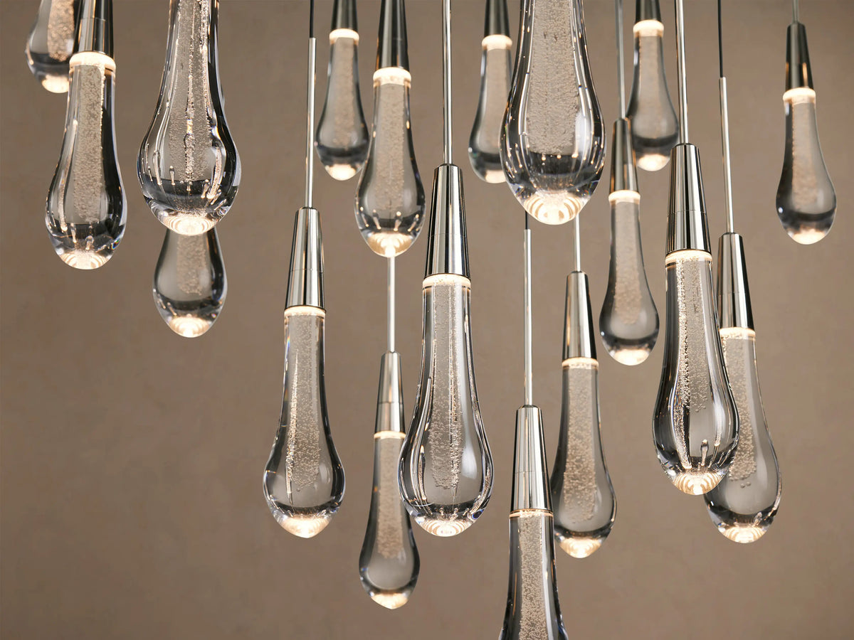 Soltaire Round Chandelier with many clear, textured glass teardrops, suspended from thin wires with polished silver caps.