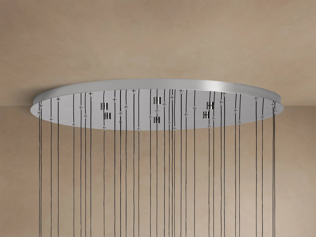 Close-up of Soltaire Round Chandelier with clear, bubbled teardrop glass pendants, polished nickel caps, glowing LED lights.