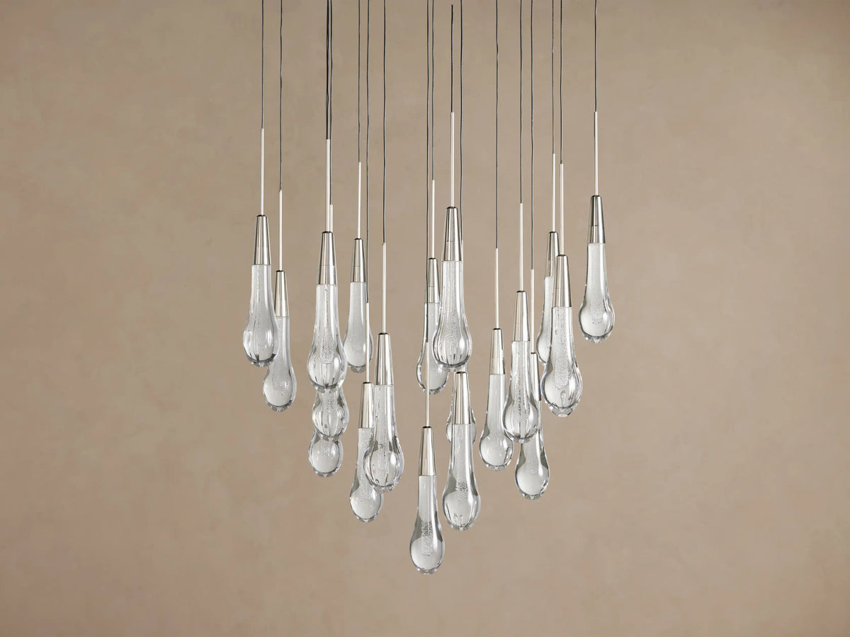Soltaire Round Chandelier featuring multiple clear, teardrop-shaped glass pendants with internal bubbles, hanging at varying heights.