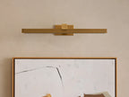 Corinth Picture Light Sconce, brushed brass, rectangular bar design with illuminated LED strip, mounted horizontally above abstract art.