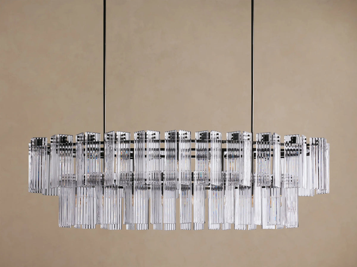 Illuminated Delsie Oval Tiered Chandelier with a dark bronze frame and multiple tiers of clear fluted glass rods.