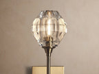 Amoroso Sconce: brass-plated wall-mounted fixture with a long arm, topped by a faceted clear crystal element.