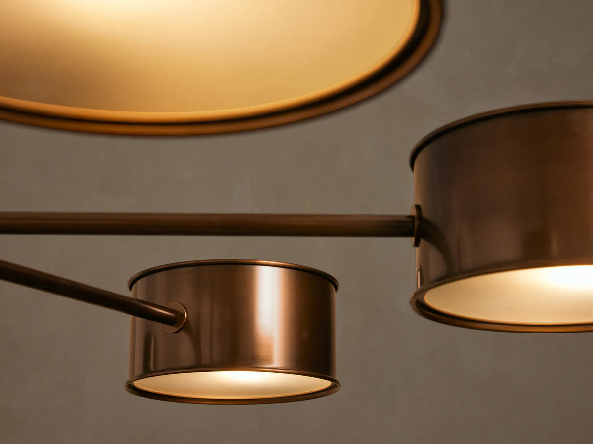 Daphne Metal Round Chandelier, warm bronze finish, 6 cylindrical shades pointing down, hanging from a rod.