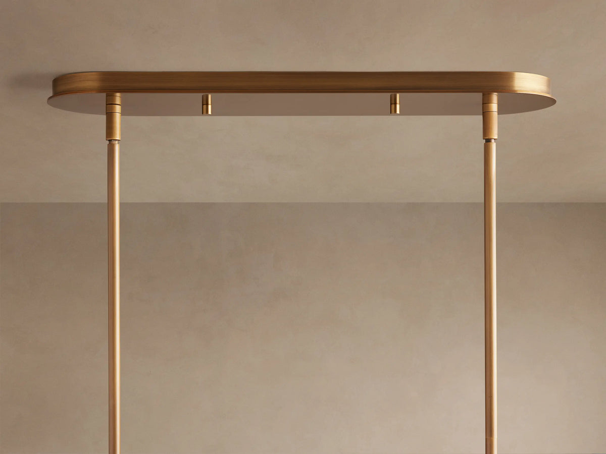 Close-up of Daphne Metal Linear Chandelier, showing several warm bronze shades with bright, glowing lights and connecting rods.