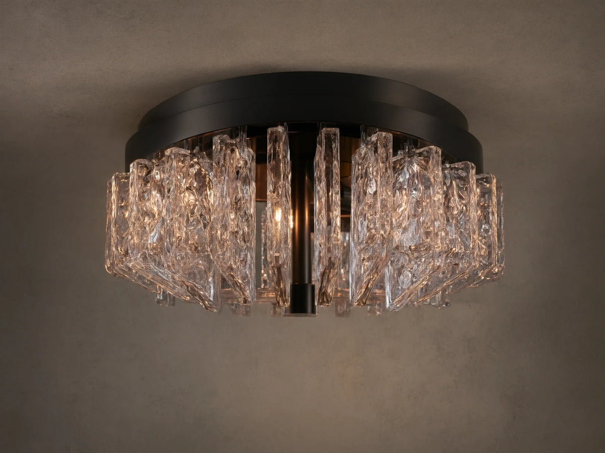 Liliana Flush Mount with a dark metal base and textured clear glass panels glowing with warm light, mounted on a ceiling.