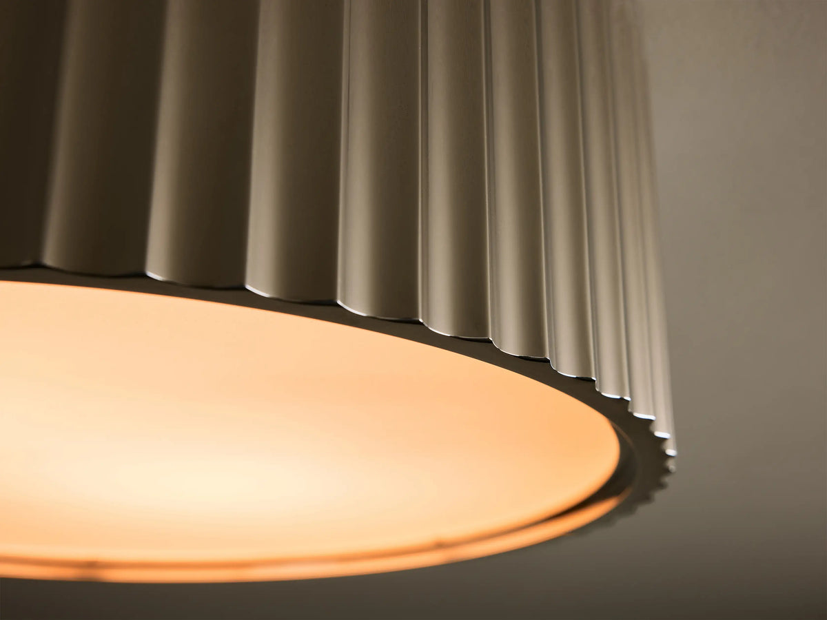 Front view of a flush mount ceiling light with a ribbed brushed nickel housing and a white frosted diffuser.