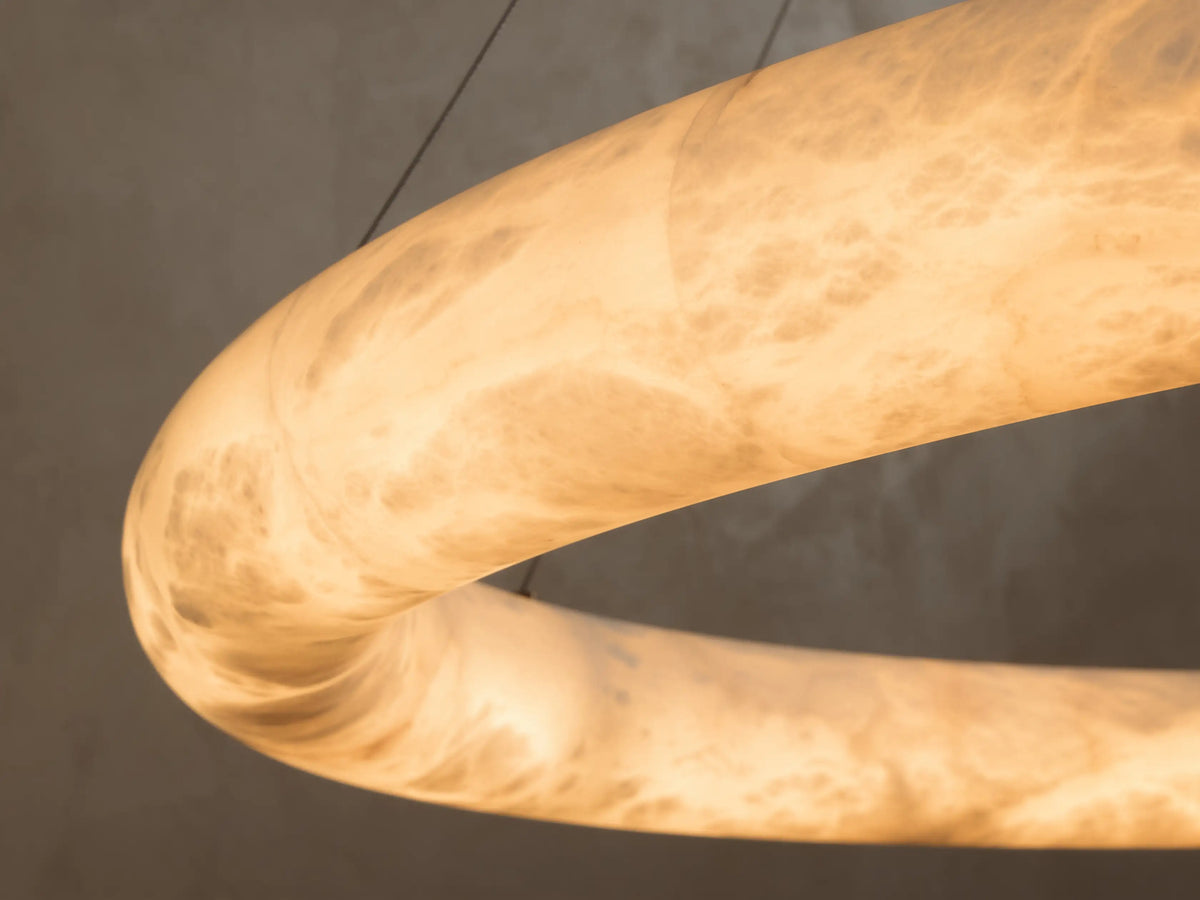 Alabaster Oval Ring Chandelier with translucent, veined surface, suspended by thin wires.