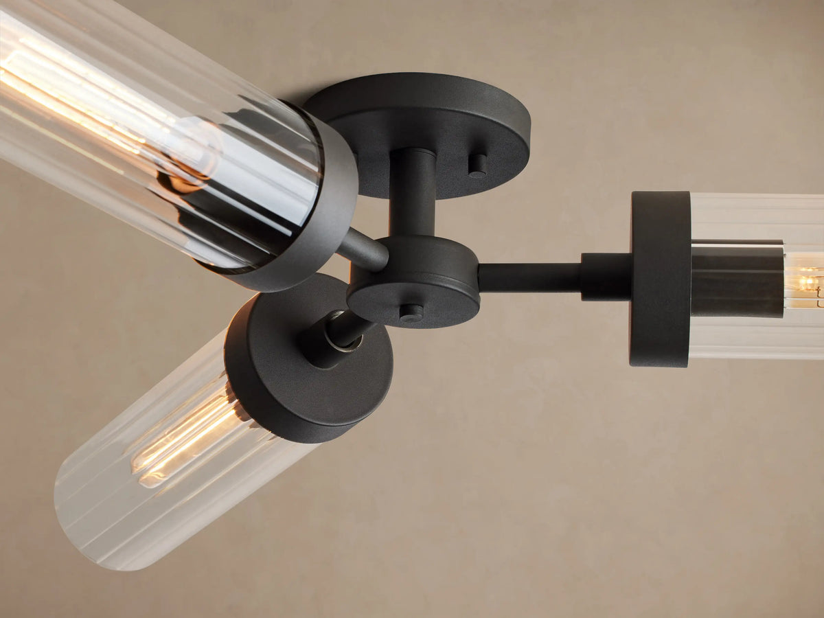 Andreas Flush Mount, black metal fixture, three clear ribbed glass shades with visible filament bulbs, mounted on a ceiling.