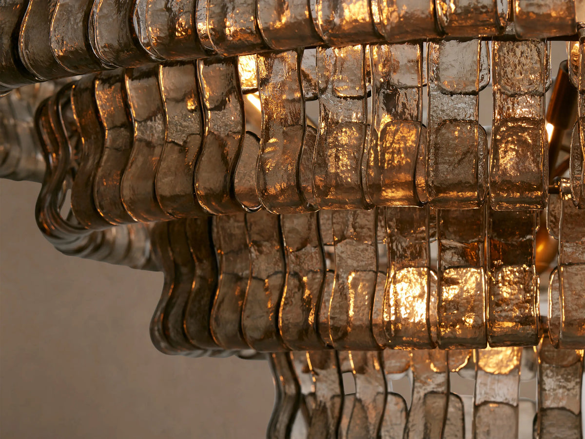 Ghiaccio Round Chandelier close-up: layered textured clear glass with warm light reflections.