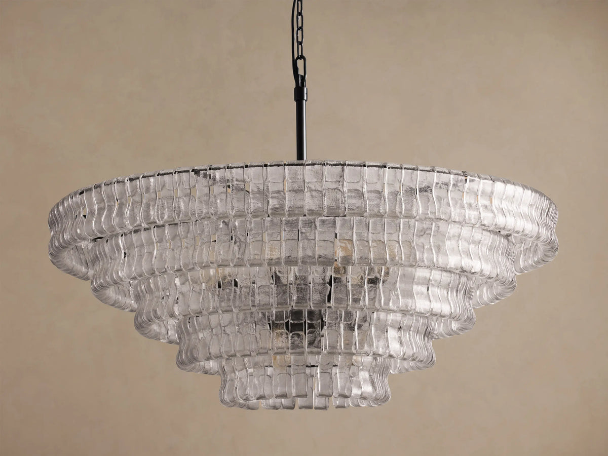 Ghiaccio Round Chandelier featuring multiple tiers of clear, wavy textured glass, suspended from a black chain.