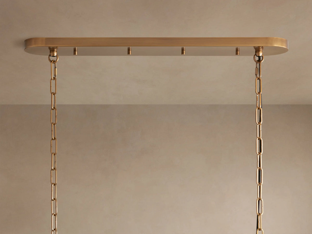 Ghiaccio Oval Chandelier close-up; clear, textured, curved glass panels reflect light, creating an icy, layered effect.