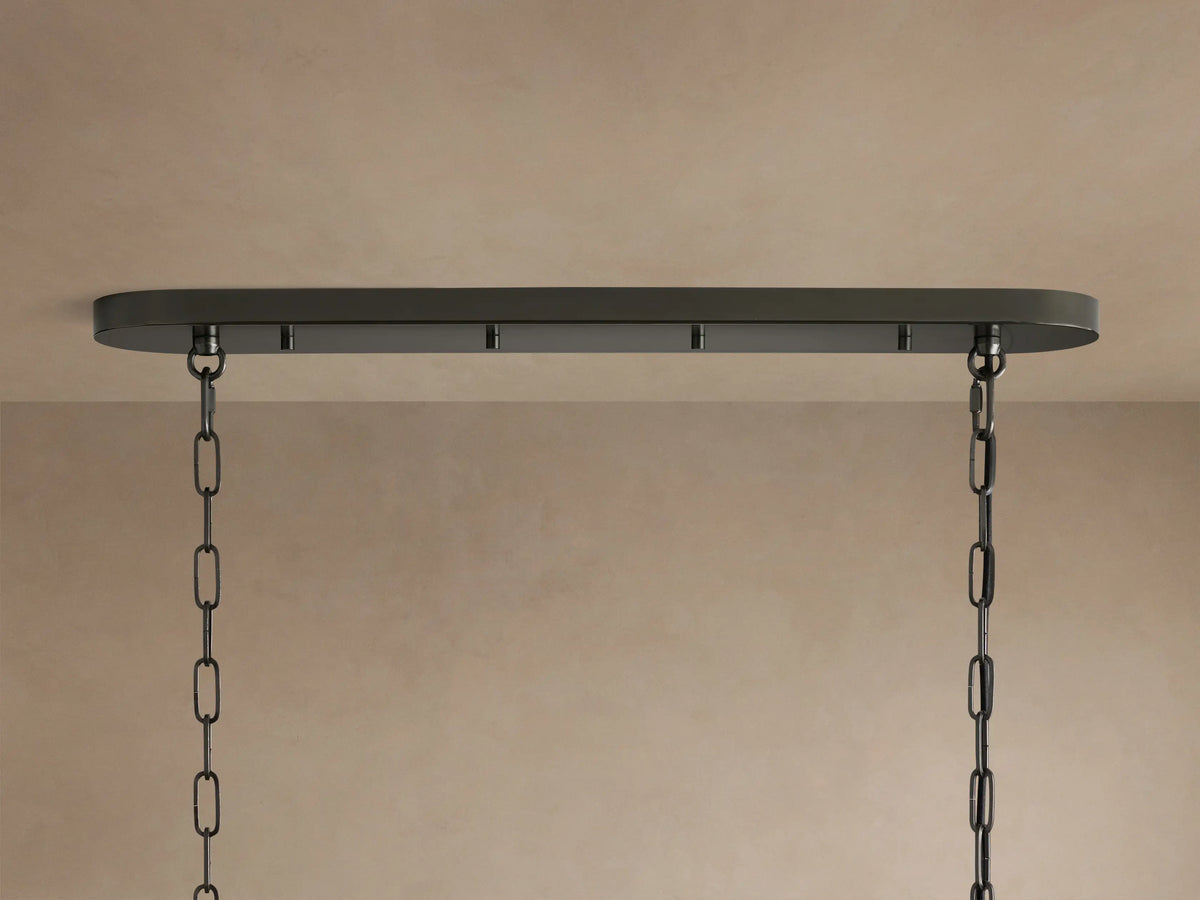 Close-up of the Ghiaccio Oval Chandelier, showcasing multiple rows of clear, curved, ice-like textured glass panels.