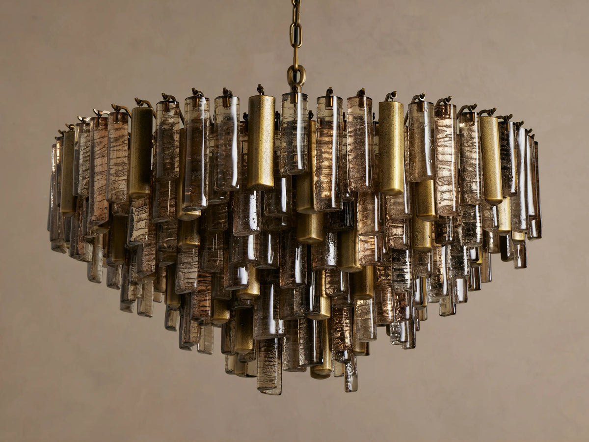 Neve Round Chandelier with shimmering champagne-finished aluminum and textured clear/bronze cast glass elements.