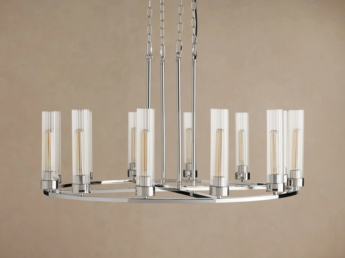 Andreas Round Chandelier, polished nickel finish, round frame, 12 glowing bulbs in clear fluted glass shades, suspended by chains.