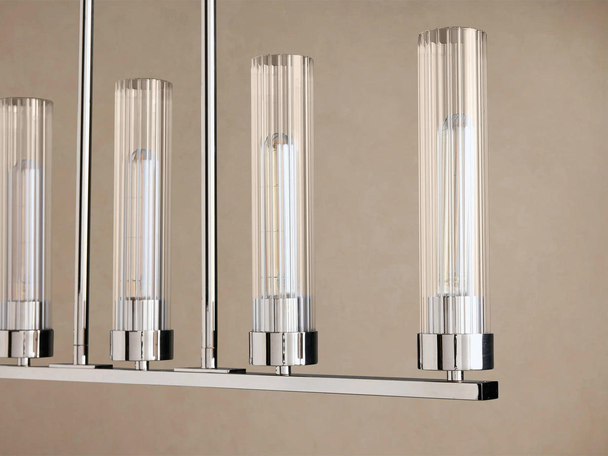 Andreas 5-Light Linear Chandelier with polished silver-toned frame, clear ribbed glass shades, suspended by chains.