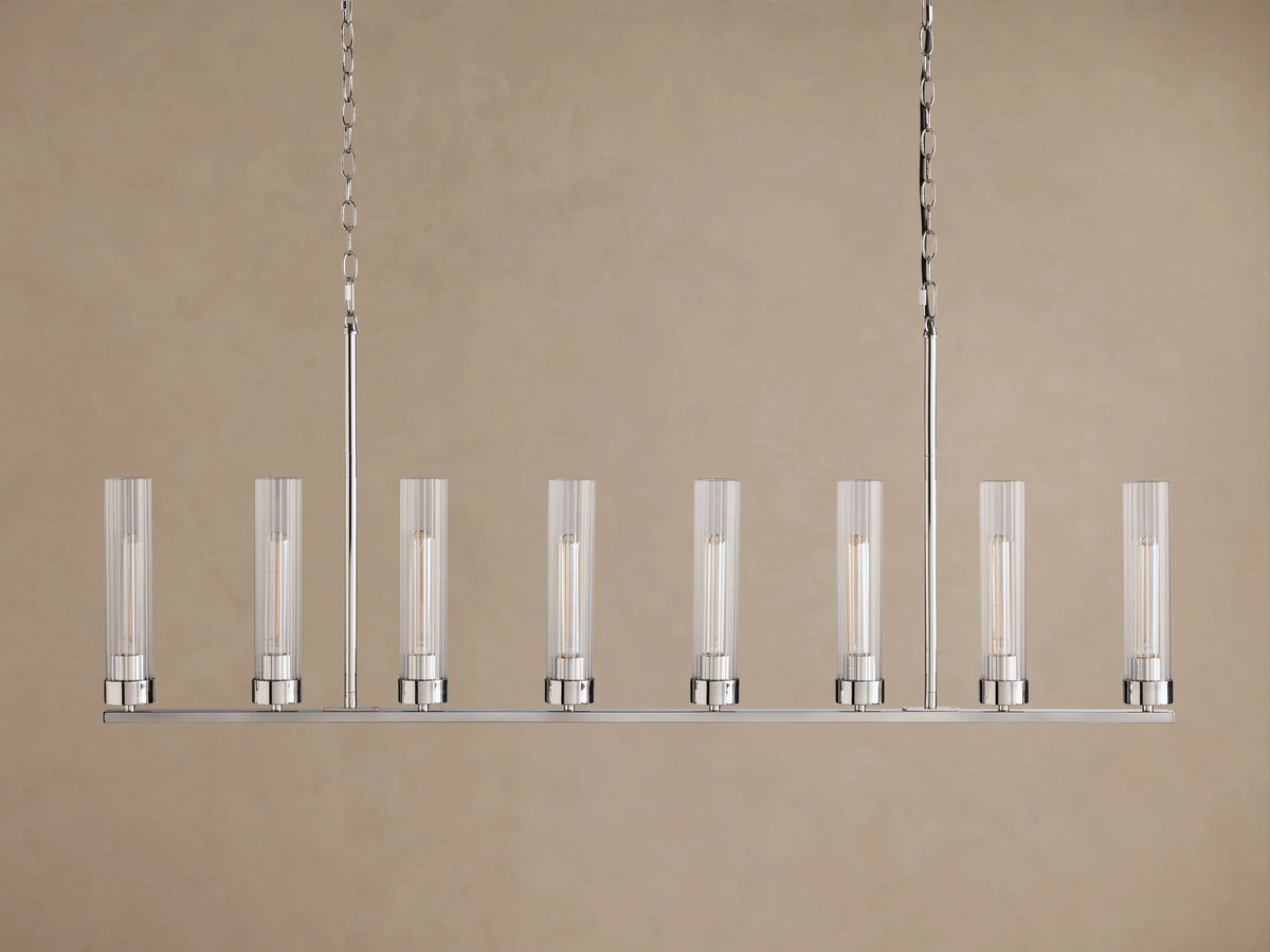 Andreas Linear Chandelier: 8-light, silver-finished linear fixture with ribbed clear glass shades & glowing filament bulbs, suspended by chains.