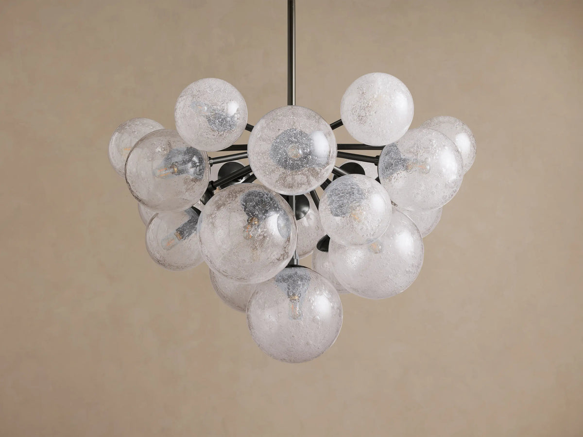 Mandoza Chandelier: Modern design with numerous textured clear glass globes on dark branching arms, against a light background.