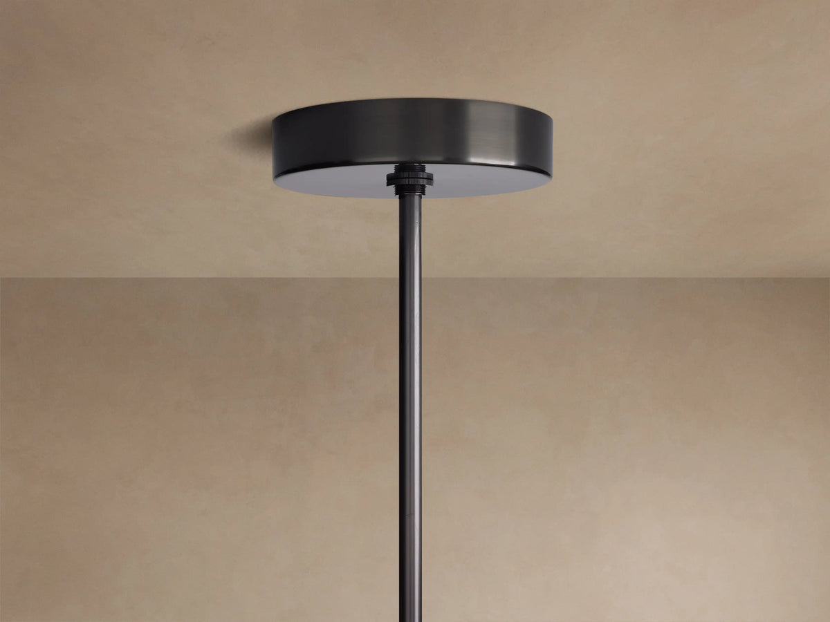 Mandoza Chandelier's dark bronze ceiling canopy and down rod mounted flush against a light beige ceiling.