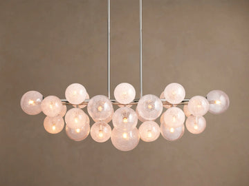 Mandoza Linear Chandelier with polished nickel frame, many illuminated, textured glass globes casting a warm glow.