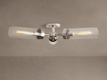 Andreas Flush Mount, polished nickel, with two horizontal clear ribbed glass shades, showcasing glowing filament bulbs.