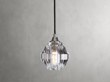 Amoroso Pendant with faceted crystal shade hanging from a black cord, showcasing a dimmable LED bulb inside.