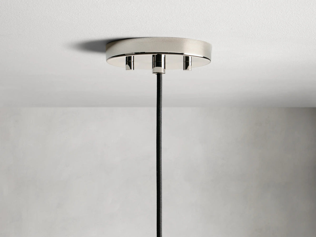 Amoroso Pendant featuring a crystal-cut shade with visible LED bulb, nickel finish cap, and black cord against a gray background.