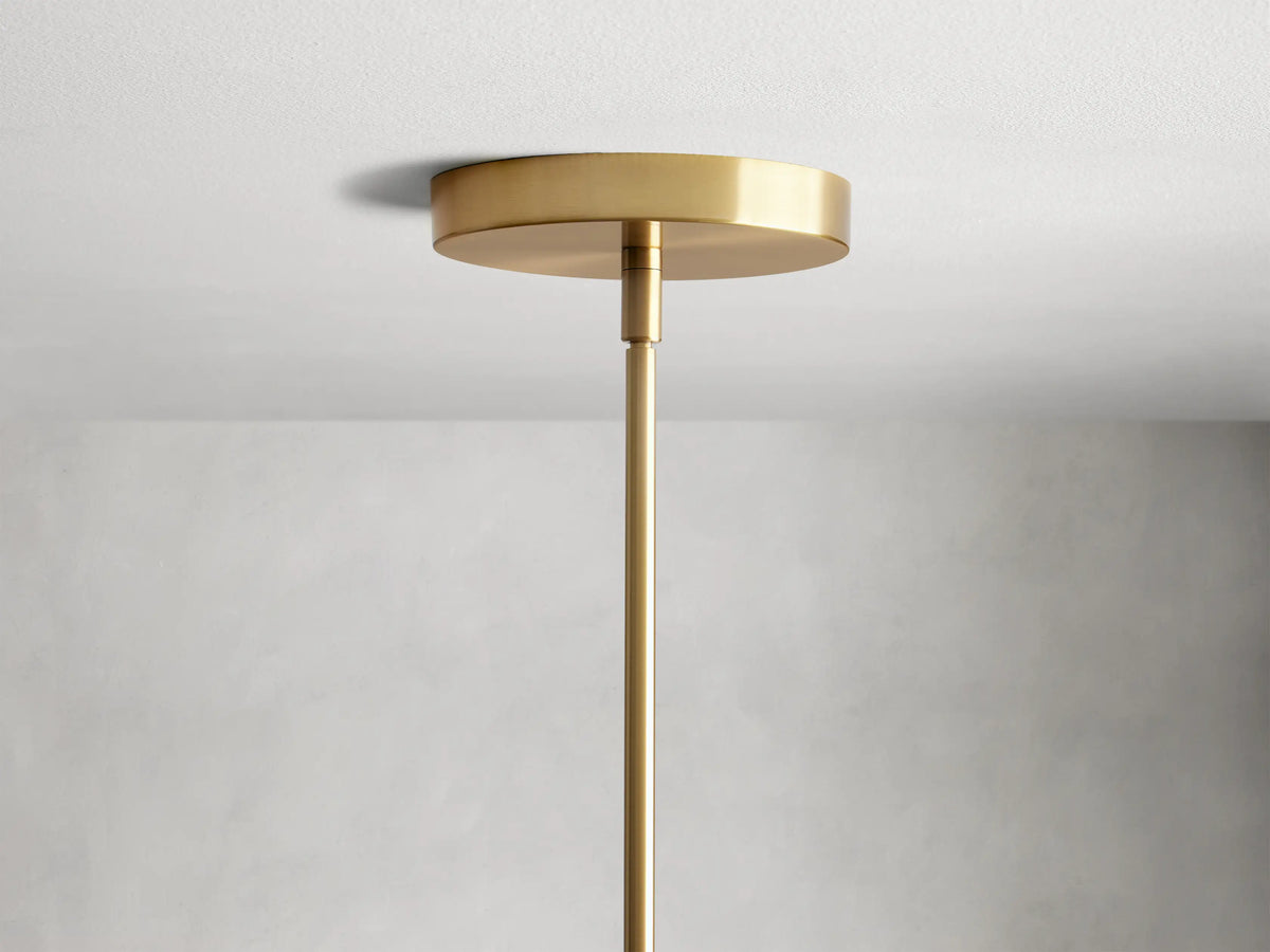 Organic 16" Pendant with amber mouth-blown glass shade, visible bulb inside, and brass fixture. Subtle texture on glass.