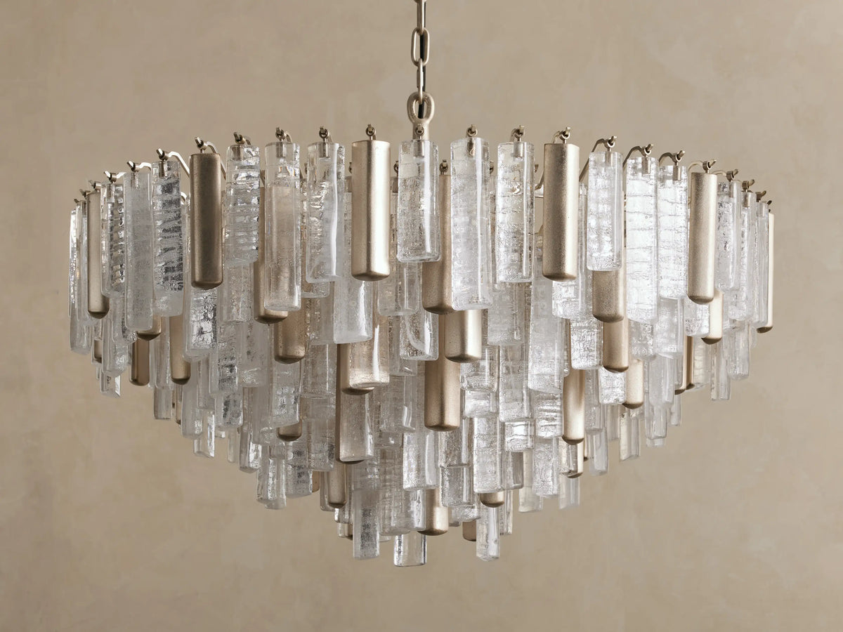 Neve Round Chandelier featuring layered clear textured glass rods & champagne aluminum cylinders, hanging.