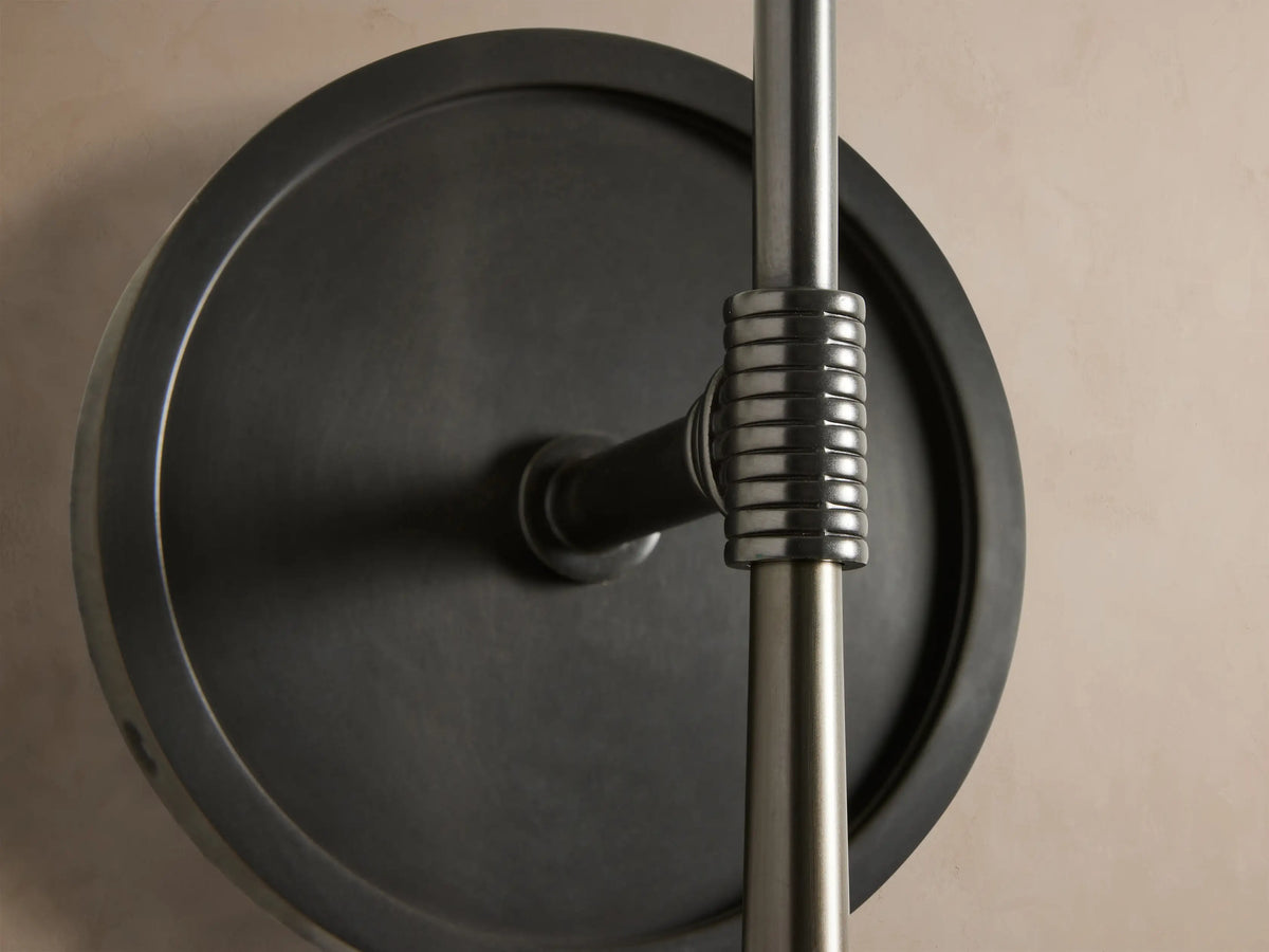 Rhodes Sconce, burnished brass finish, with a round backplate & straight arm, holding an upright white tapered linen shade.