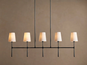 Rhodes Linear Chandelier with 5 tapered light linen shades on a dark metal horizontal bar, hanging from two rods.
