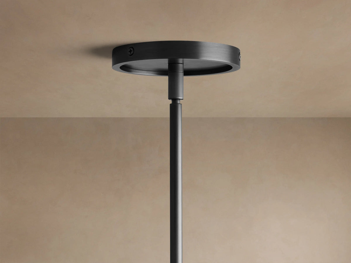 Close-up of Rhodes Round Chandelier's dark metal frame with ribbed detail & two light linen shades against a beige wall.