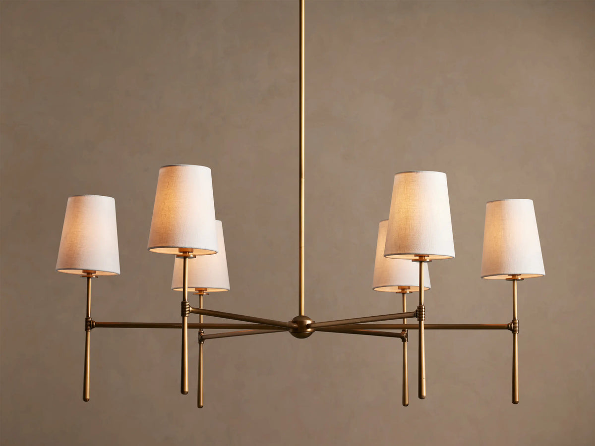 Rhodes Round Chandelier, 6-light, with burnished brass frame & 6 glowing tapered linen shades.