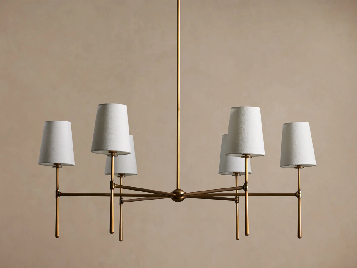 Rhodes Round Chandelier, 6-light, with burnished brass frame & 6 glowing tapered linen shades.