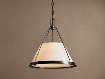Shelton Pendant: conical light linen shade with dark bronze metal frame, suspended from a matching chain against a neutral background.