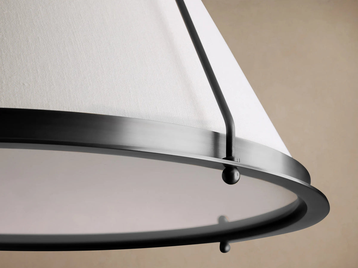 Shelton Flush Mount: a black metal frame holds a large, tapered white linen shade, mounted flush against a light brown ceiling.