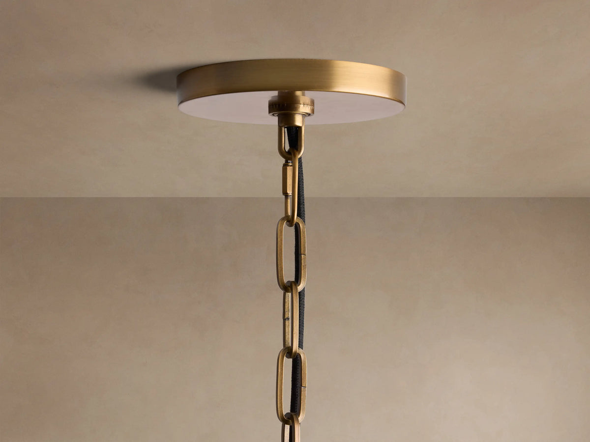 Close-up of Shelton Pendant with burnished brass frame, tapered textured linen shade, and frosted glass diffuser.