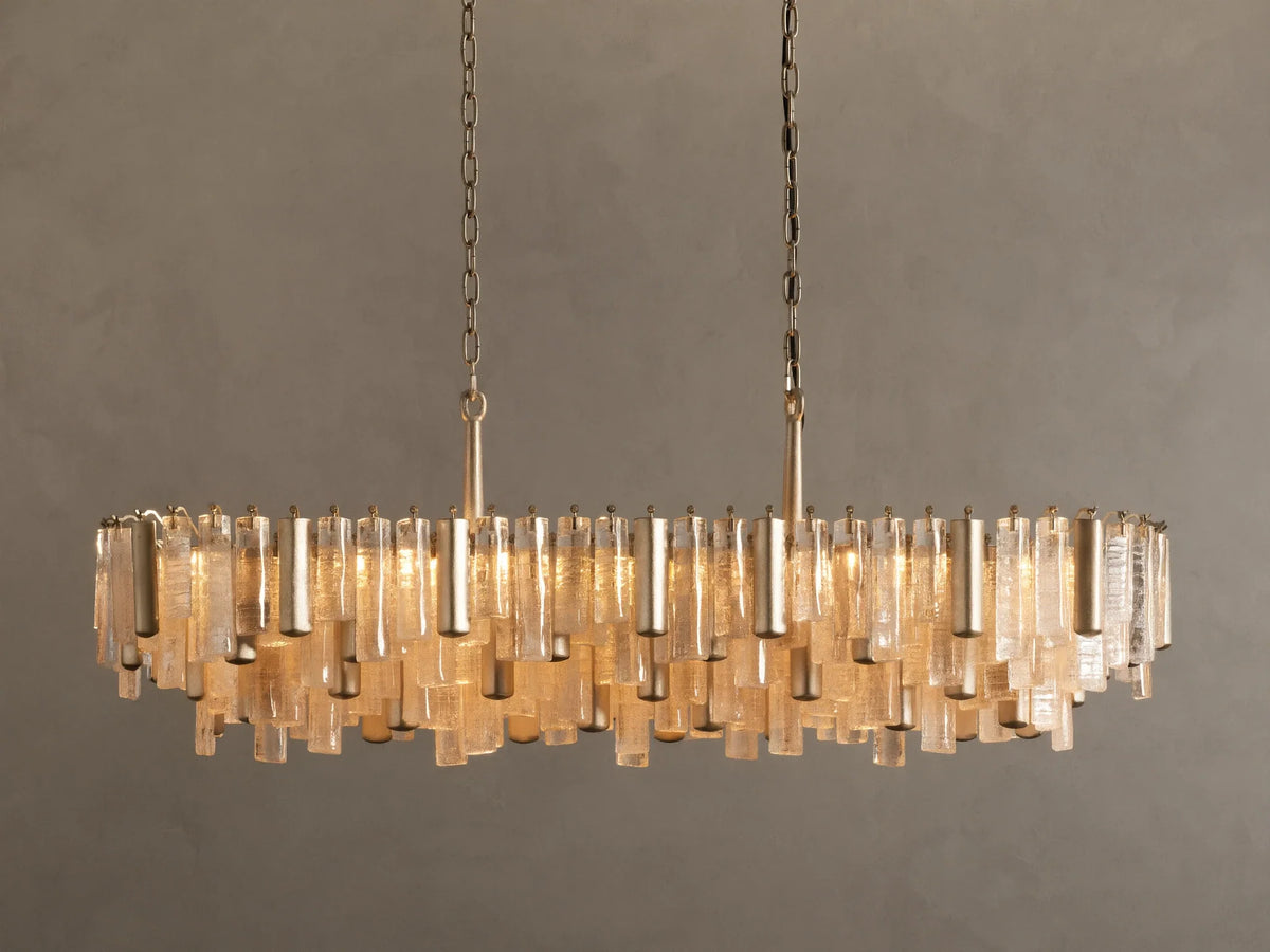 Neve Linear Chandelier: Oval-shaped with numerous illuminated clear cast glass rods of varied lengths, suspended from brass chains.