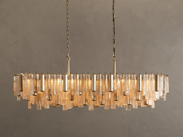 Neve Linear Chandelier: Oval-shaped with numerous illuminated clear cast glass rods of varied lengths, suspended from brass chains.