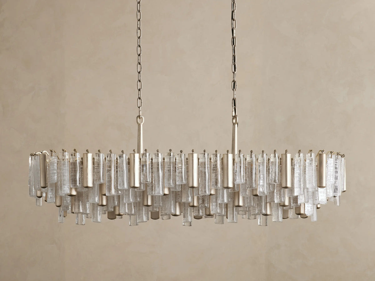 Front view of Neve Linear Chandelier, rectangular, with textured clear glass and champagne-finished metal elements, hanging.