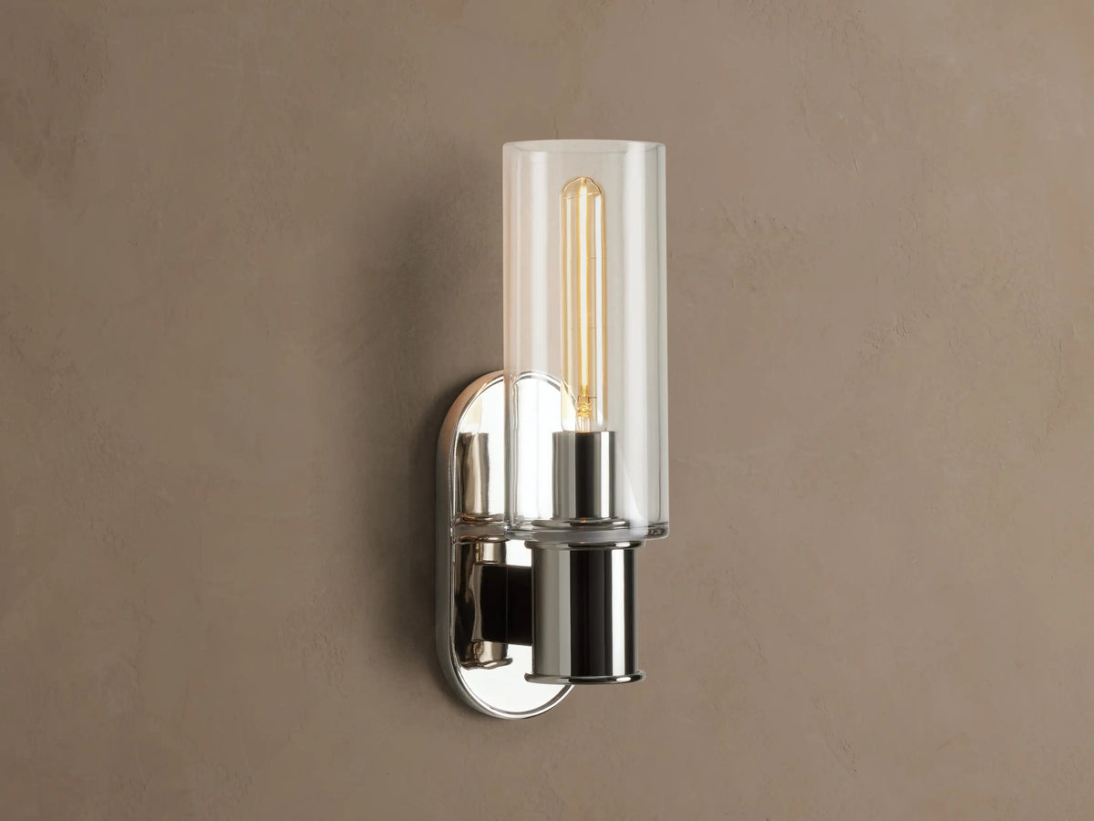 Harlin Sconce with polished nickel finish and clear glass cloche, mounted vertically on a wall, showing an Edison bulb.