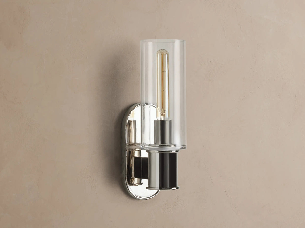 Harlin Sconce with polished nickel finish and clear glass cloche, mounted vertically on a wall, showing an Edison bulb.