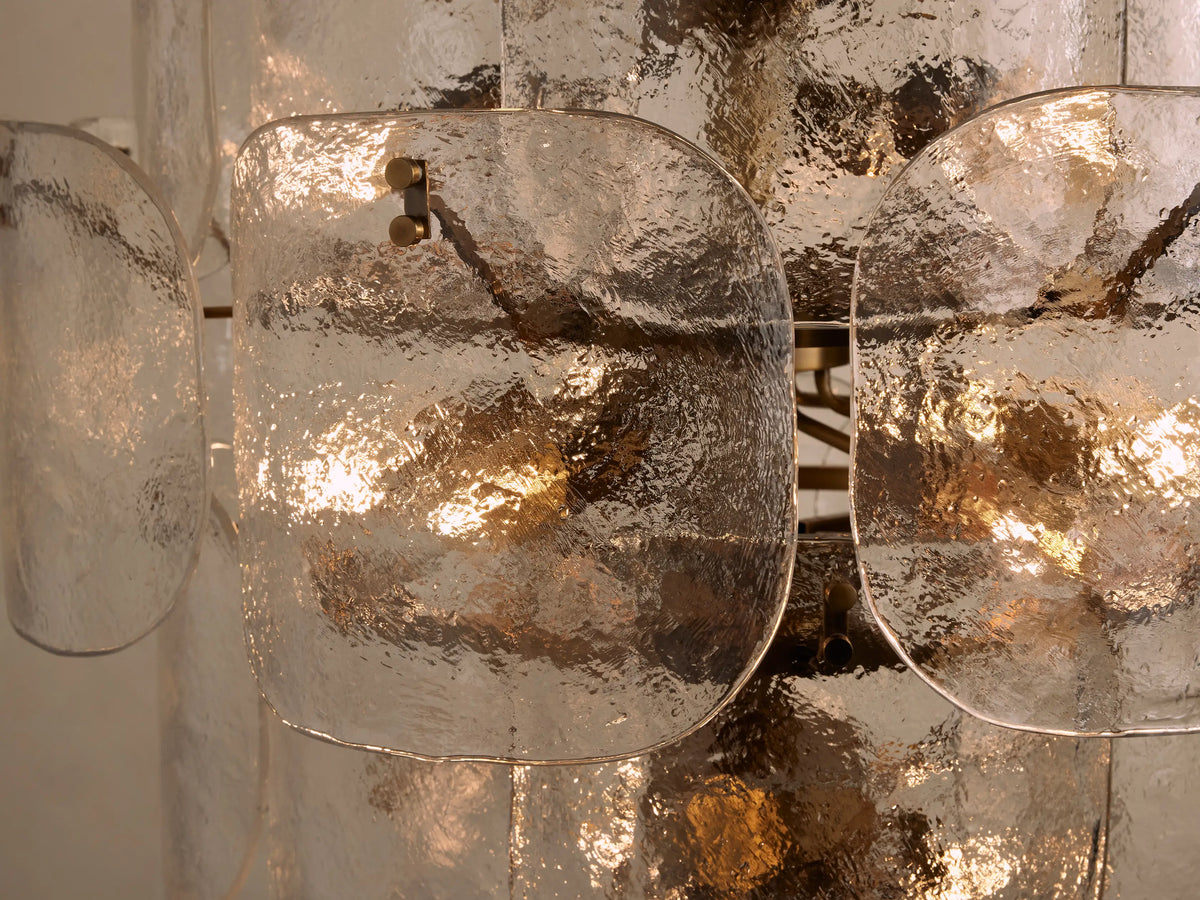 Blaire Round Chandelier with layered, curved molten glass panels showcasing a pearlescent, bubbled texture over a brass frame.